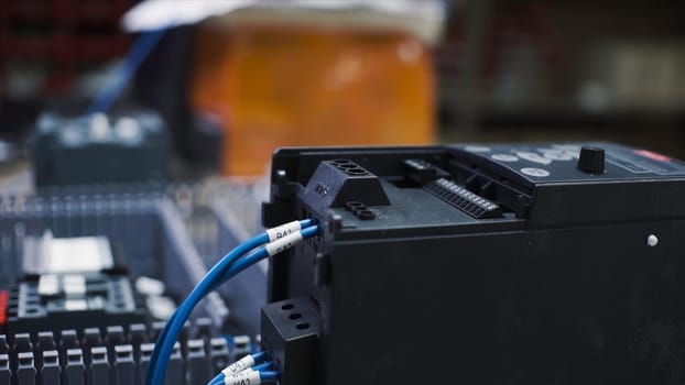 Close-up of charging electric battery with wires. Clip. Black battery box for large electrical equipment is on charge. Electric battery with connected wires is on charge.