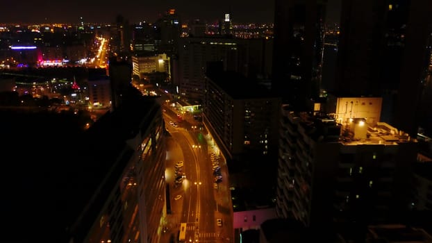 Dubai skyline at night with beautiful city with lights close to it's busiest highway. Beautiful night views of Dubai. Aerial.