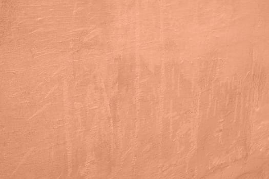 Peach Fuzz toned colour grunge decorative wall background. Art rough stylized texture banner trendy color 2024. Grunge Peach Fuzz color texture. High quality photo