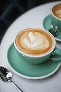 Coffee cup on wood table .