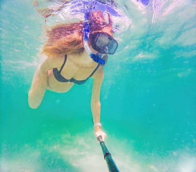 In an ethereal underwater scene, a pregnant woman gracefully floats, embodying the beauty of maternity beneath the tranquil surface of the sea.