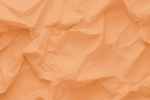 Crumpled paper Peach Fuzz color of the year 2024. Texture crumpled paper for your design. Copy space. High quality photo