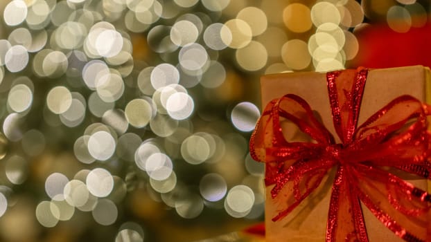 Christmas gift or present box, against magic bokeh background. Beautiful Christmas gift boxes with ribbon.