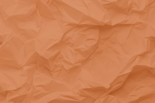 Crumpled paper Peach Fuzz color of the year 2024. Texture crumpled paper for your design. Copy space. High quality photo