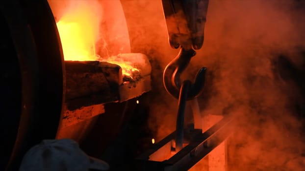 Hot steel pouring at steel plant. Stock footage. Flowing metal at the foundry. Pouring of liquid metal in open hearth workshop.