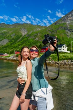 In a trendy urban environment, a stylish woman passionately captures a selfie using a professional camera, epitomizing modernity and creative enthusiasm in photography.