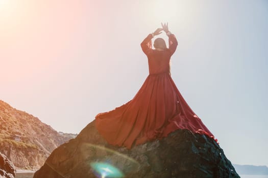 Woman travel sea. Happy tourist taking picture outdoors for memories. Woman traveler looks at the edge of the cliff on the sea bay of mountains, sharing travel adventure journey.