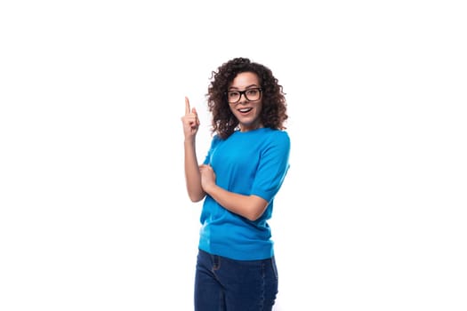 young successful leader woman with curly hair dressed in a blue t-shirt.