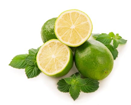 Fresh limes, mint leaves isolated on white