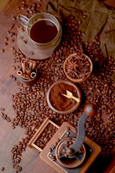 Tasty steaming espresso in cup with coffee beans. View from above. Dark background.