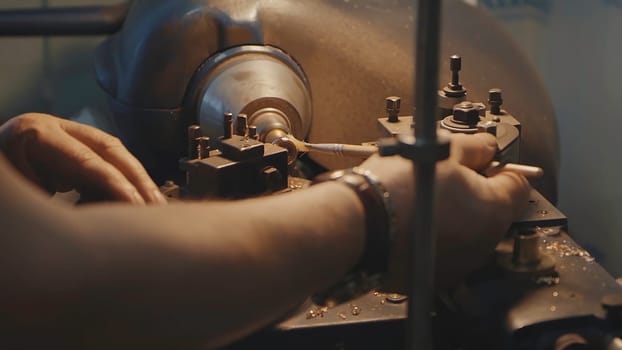 Production of rings. Jeweler working with wax model ring in his workshop. Craft jewelery making. Detail shot with low depth of field. Jeweler making handmade jewelry on vintage workbench. Craft of jewelery making. Repairing ring by inlaid tight gem.
