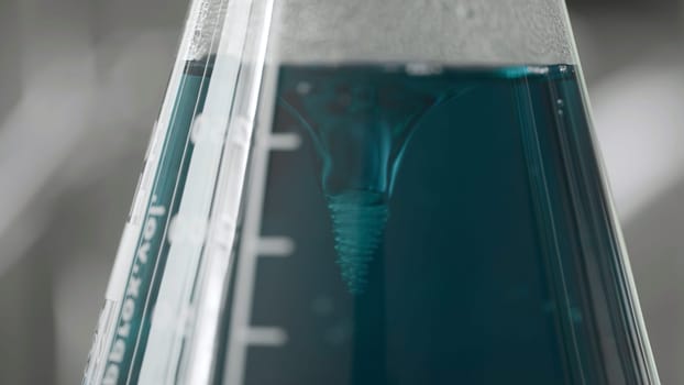 Chemical process. Action.Chemical reaction with blue bubbling water in a special test tube. High quality 4k footage