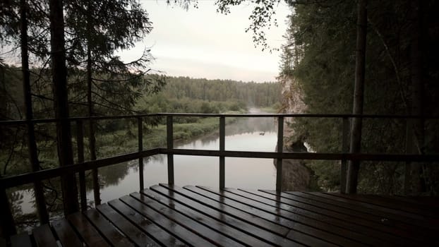 Landscape with river flowing in forest area in cloudy weather. Stock footage. Top view of forest valley with river and horizon with cloudy sky.