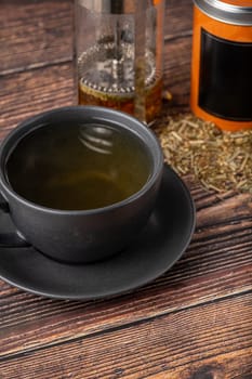 Freshly brewed hot winter tea on a wooden table