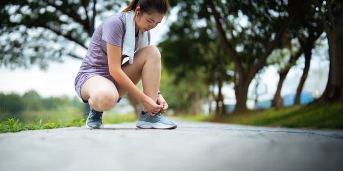 Young woman stretch during stretching exercise outdoors in the park.