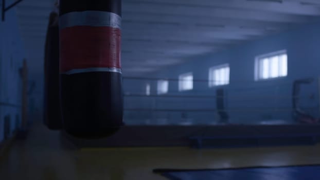 Interior of a fitness hall with a punching bag. Punching bag in the hall.