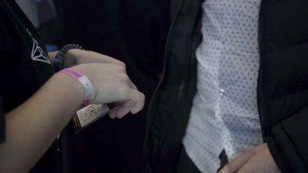 Close up of hands of the inspector checking the tickets at the entrance. Ticket control in cinema. Ticket control in movie theater.