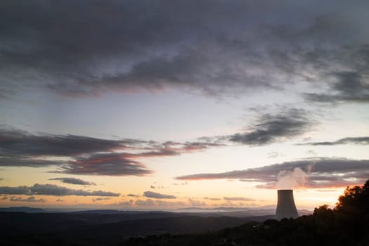 Sunset at the power plant for the exploitation of boraciferous blowers for the production of electricity in Tuscany, Italy 