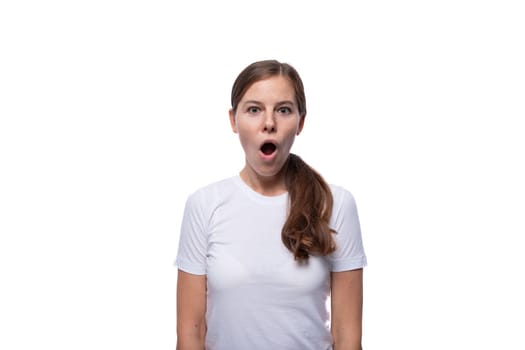 Young woman looks at the camera in surprise with her mouth open.