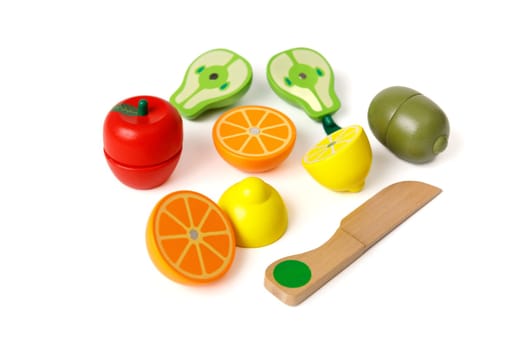 Educational children's set of toys in the form of cut fruits and a wooden knife, isolated on white background.