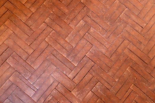 Old ceramic tile geometric shapes parquet on floor.