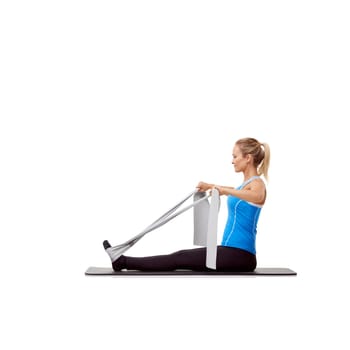 Fitness, resistance band and woman doing exercise in studio for health, wellness and bodycare. Sport, yoga mat and young female person from Australia with arms workout or training by white background.