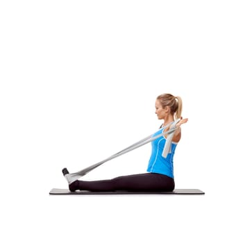 Fitness, resistance band and woman doing exercise in studio for health, wellness and bodycare. Sport, yoga mat and young female person from Australia with arms workout or training by white background.
