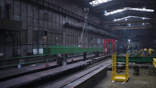 I-beam bridge crane. Clip. Warehouse with large yellow metal beams. Industrial warehouse with overhead crane main beams and truck.
