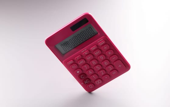 Close-up of red calculator with numbers on screen, work on battery. Calculations, accounting, computing, profit, loss, tax, banking concept. Copy space