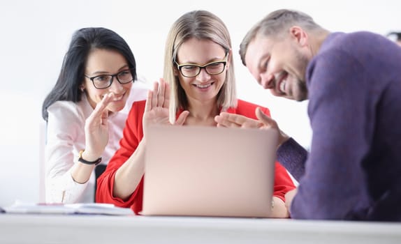 Group of business people waving laptop screen. Online negotiations with partners concept