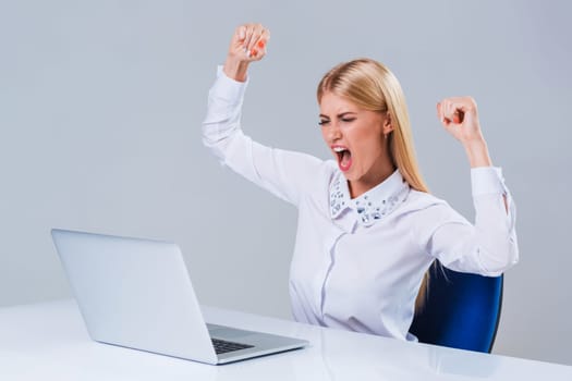 Young businesswoman working at laptop computer. she is happy pleased