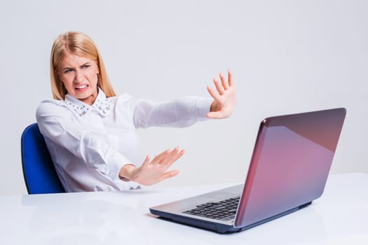 Young businesswoman working at laptop computer. pleasantly surprised dissatisfied girl