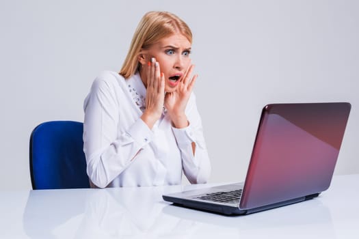 Young businesswoman working at laptop computer. pleasantly surprised dissatisfied girl