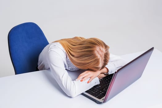 Young businesswoman working at laptop computer. tired girl soon fell asleep stress