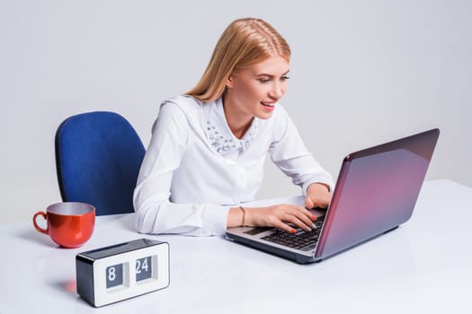 Young businesswoman working at laptop computer. Pretty smiling girl