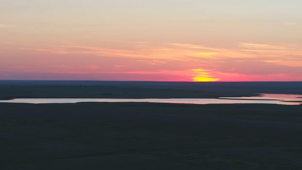 Aerial view of beautiful emerald green water lake and summer landscape sunset. Sunset on the lake.