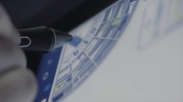 Graphic designer working with a tablet and stylus in the office. Close up of an artist drawing a portrait of long haired teenager.