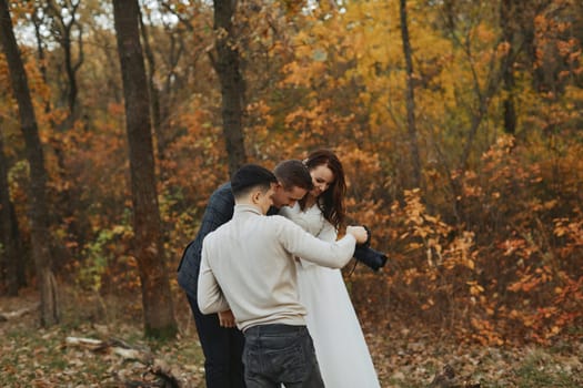 wedding photographer shows just taken photos to wedding couple. bride and groom in nature