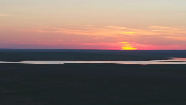 Aerial view of beautiful emerald green water lake and summer landscape sunset. Sunset on the lake.