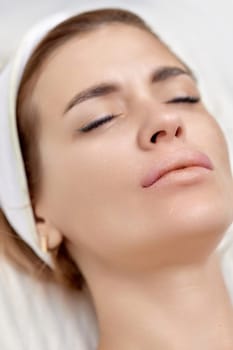 woman receives cosmetic injection in lips. Woman in beauty salon.