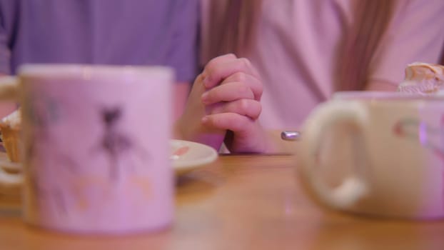 Close-up of children's hands joined together. Stock footage. Children's mugs on background of children's hands. Children's romance and first love.