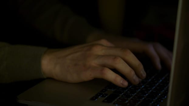 Close up for man hands typing fast on laptop computer, business, education, people and technology concept. Male hands of a young man typing fast.
