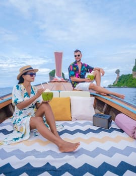 A couple man, and woman on a trip to the tropical island 4 Island trip in Krabi Thailand. Asian woman and European man mid age on vacation in Thailand.