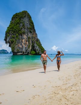 Railay Beach Krabi Thailand, the tropical beach of Railay Krabi, a couple of men and women on the beach, Panoramic view of idyllic Railay Beach in Thailand on a sunny day