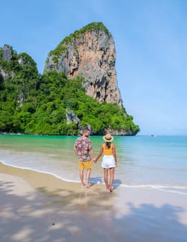 Railay Beach Krabi Thailand, the tropical beach of Railay Krabi, a couple of men and women on the beach, Panoramic view of idyllic Railay Beach in Thailand on a sunny day