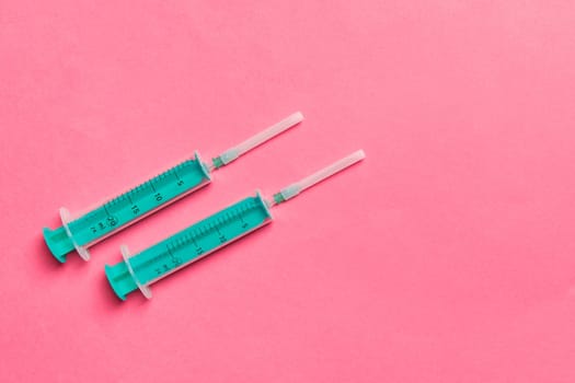 Top view of medical syringes on colorful background with copy space. Injection equipment concept.