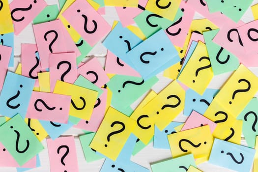 colorful paper notes with question marks. Closeup.