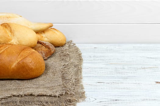 Bread baguettes on rustic white painted wood.