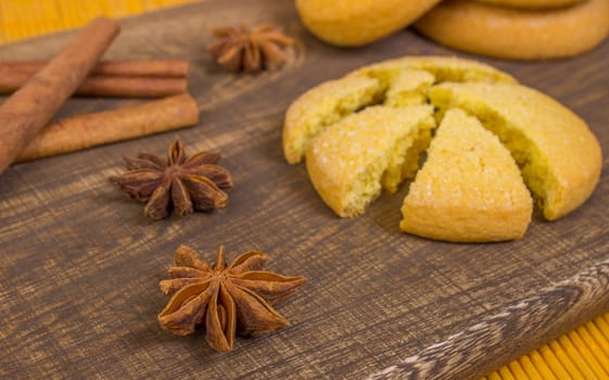 Cinnamon sticks with star anise on board with cookie