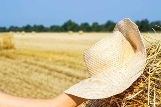 Working hat of a farmer on a haystack. Agriculture Concept.Harvest concept